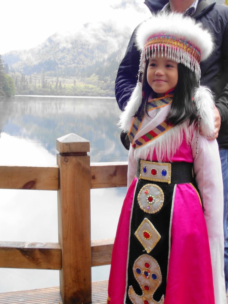 Local girl in traditional dress, Jiuzhaigou National Park Jiuzhaigou National Park, Customer Corner: 