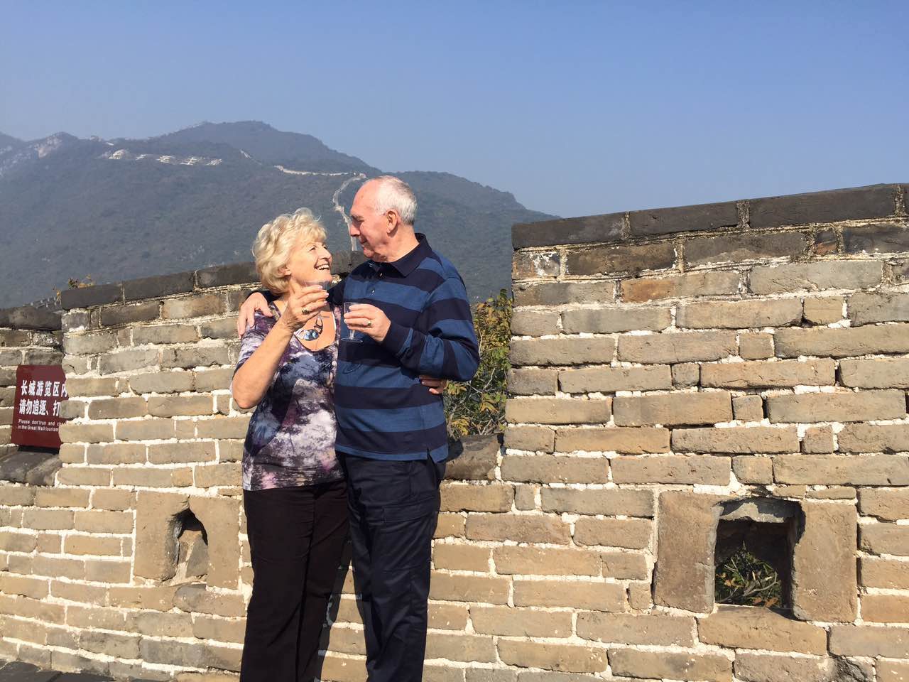 Customers drinking sparkling wine on the Great Wall, Deluxe