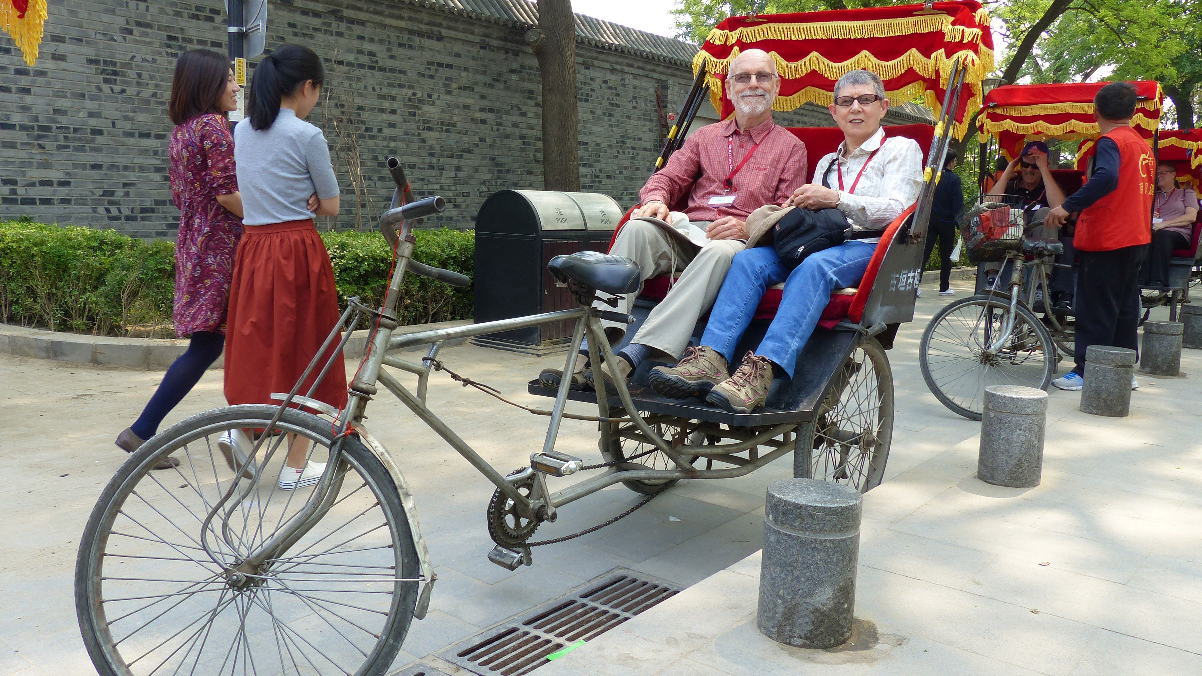 Customers on a rickshaw in Beijing, travel buddy