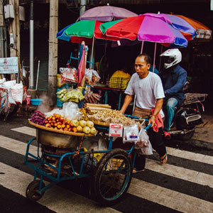Image - Man with food truck in street market